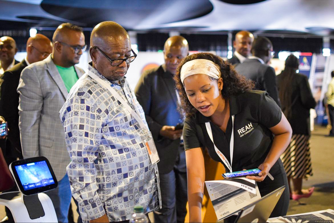 Person working on laptop with Mbula logo